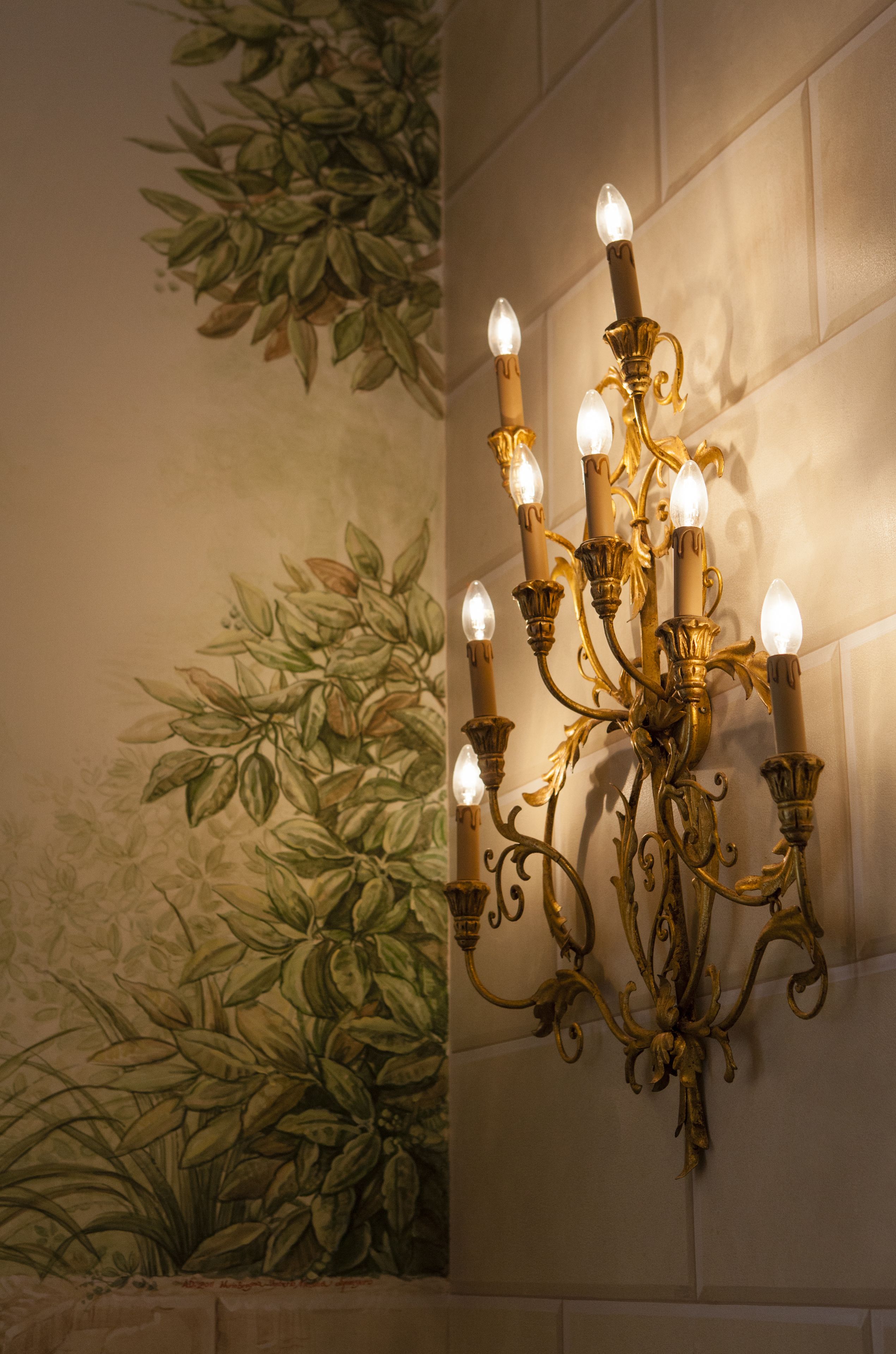 A wall-mounted chandelier with multiple light fixtures.