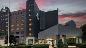 A modern building with multiple floors and a prominent sign for 'Embassy Suites'. - Embassy Suites Hotel Charlotte (Charlotte)
