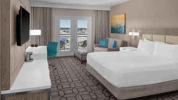 Habitación, 1 cama King size, balcón | Área de sala de estar | Televisión de pantalla plana