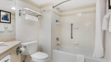 A modern bathroom with a toilet, sink, and bathtub.