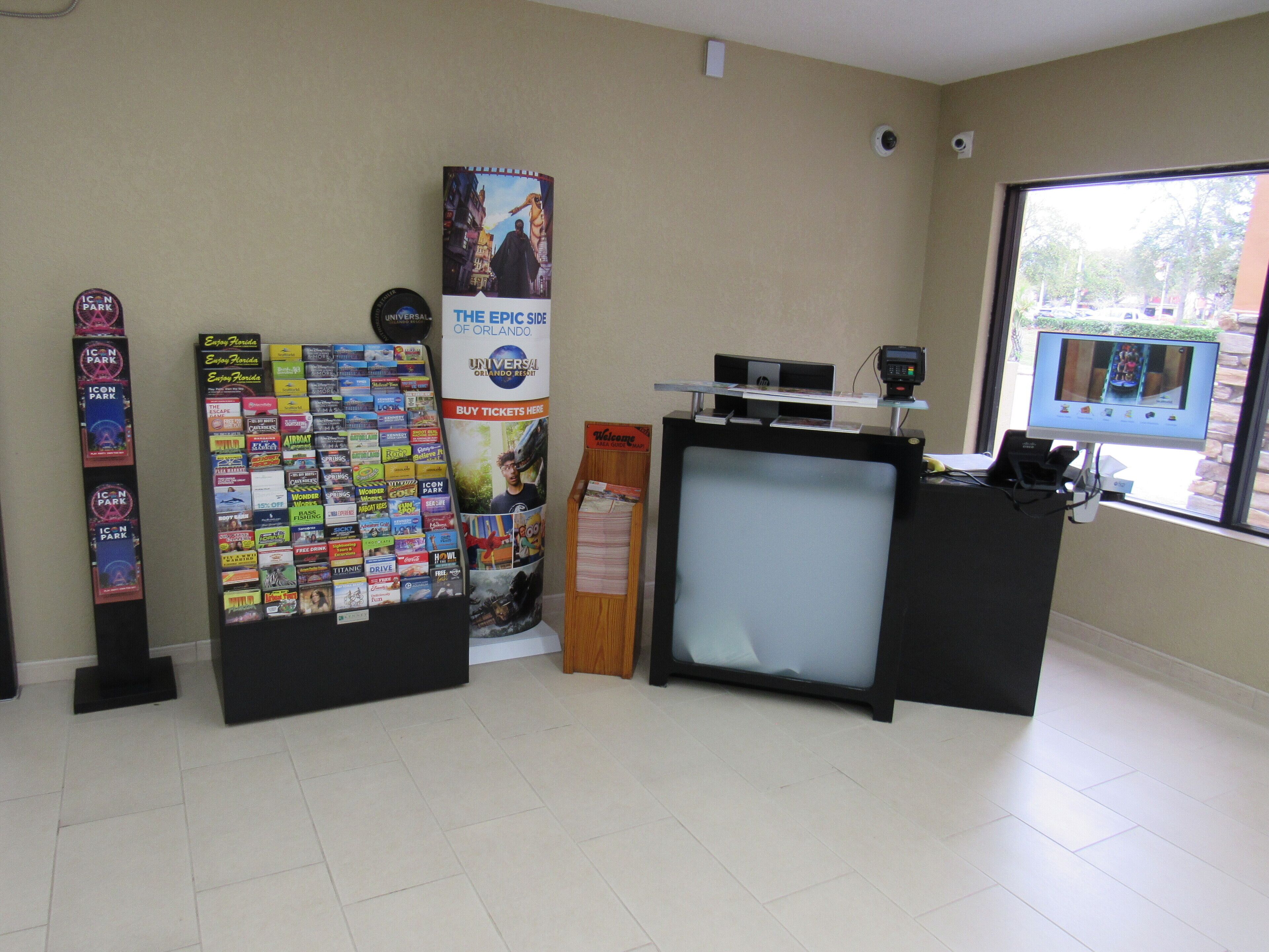 A ticket booth area with a large poster advertising Universal Orlando Resort, a ticket counter, and a display of various tickets.