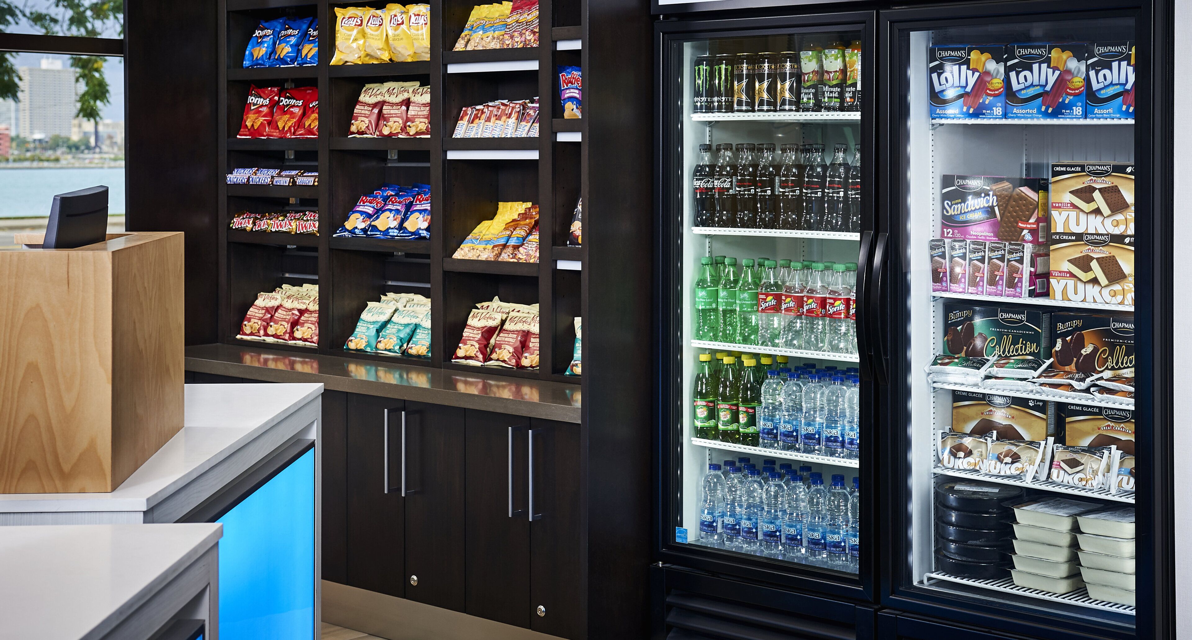 A vending machine stocked with snacks, drinks, and ice cream.