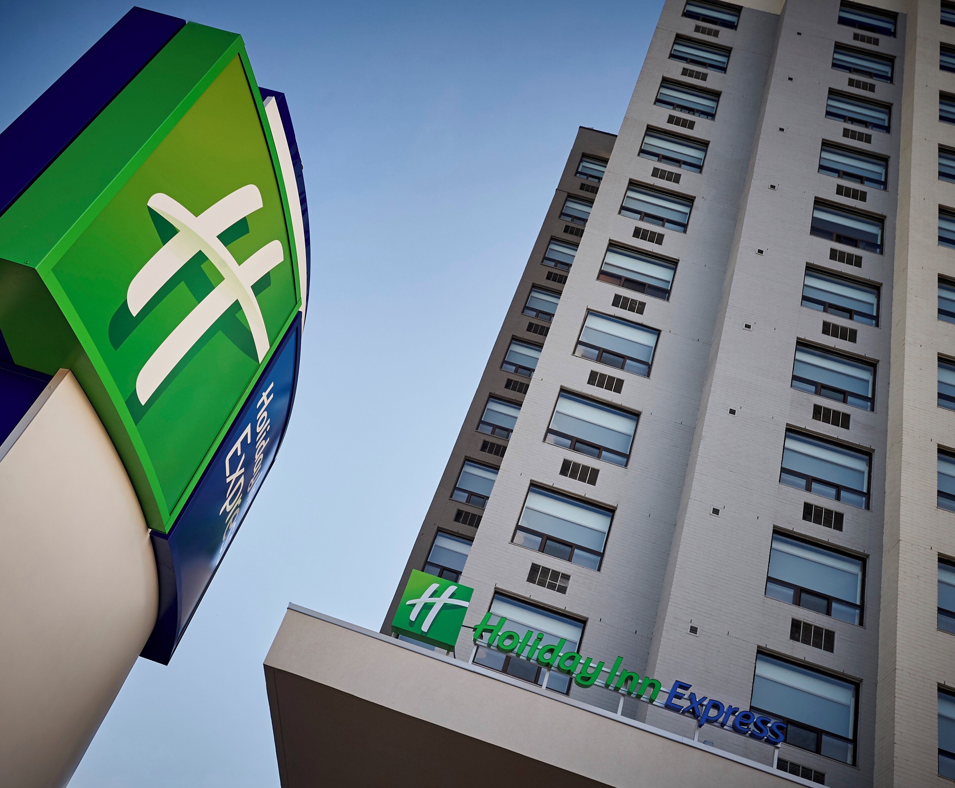 A tall building with a Holiday Inn Express sign on the side.
