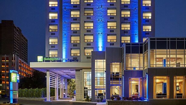 A multi-story hotel with a prominent entrance and a Holiday Inn Express sign. - Holiday Inn Express Windsor Waterfront by IHG (Windsor)