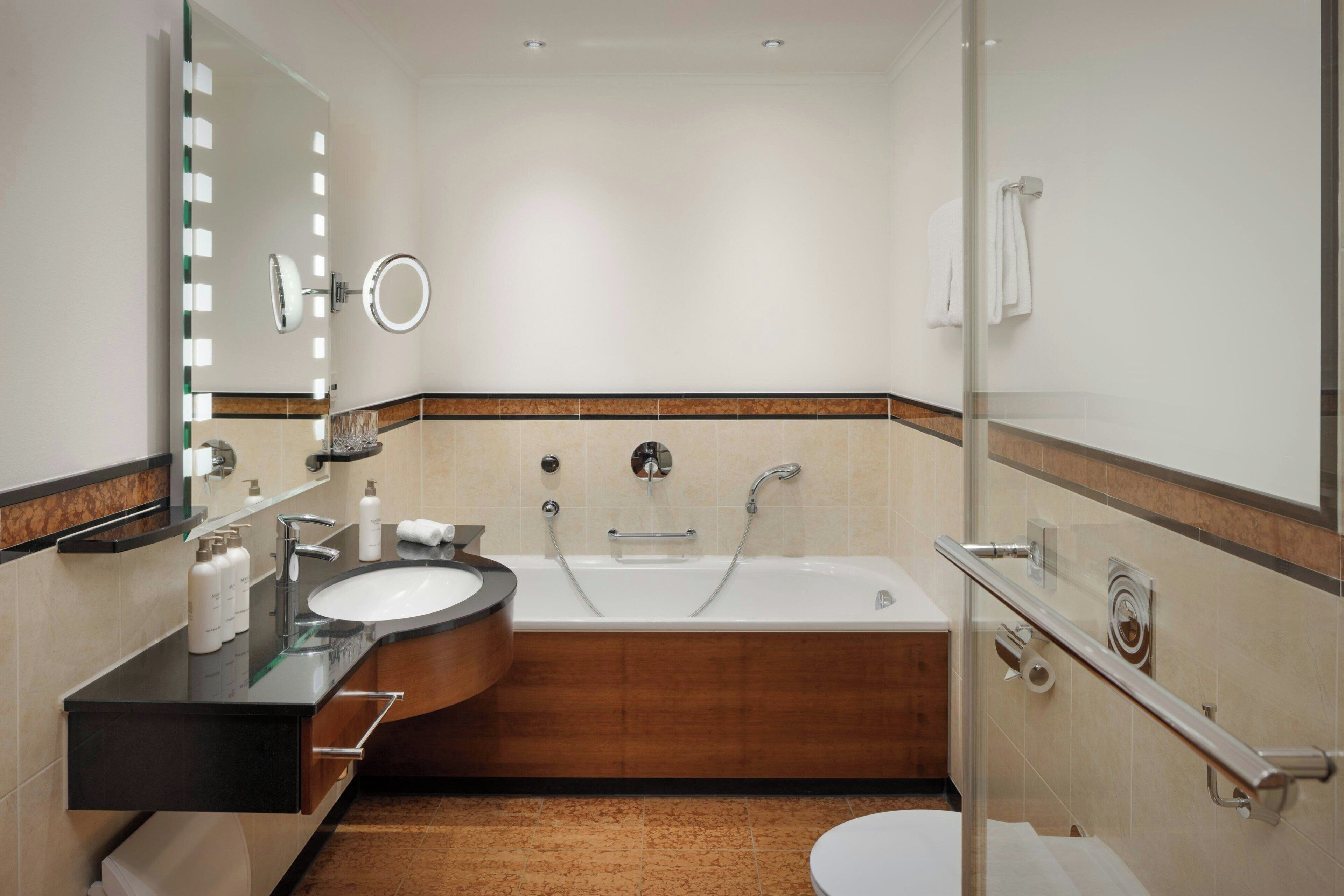 A modern bathroom with a bathtub, a sink, and a toilet.