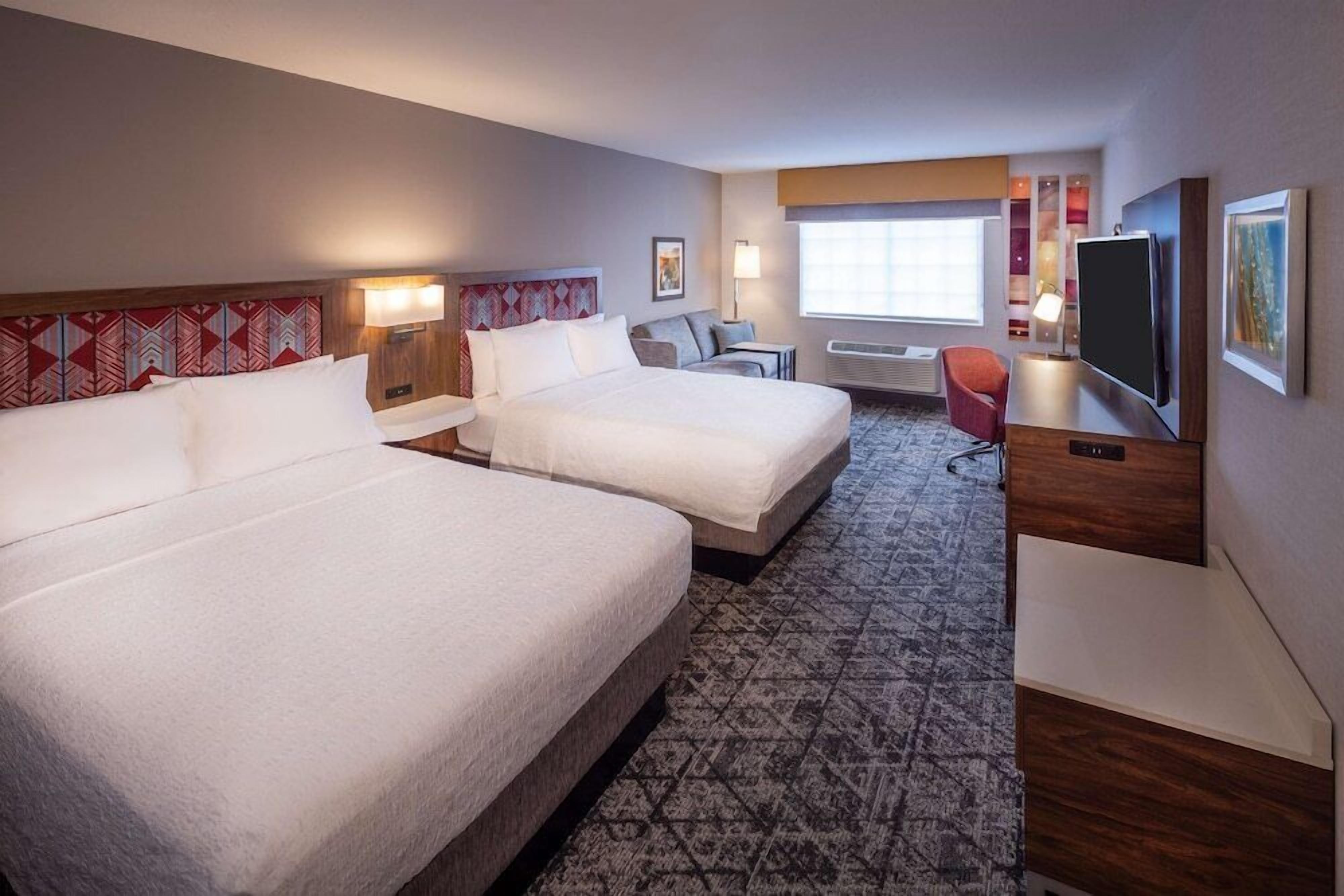 Hypo-allergenic bedding, desk, laptop workspace, blackout drapes