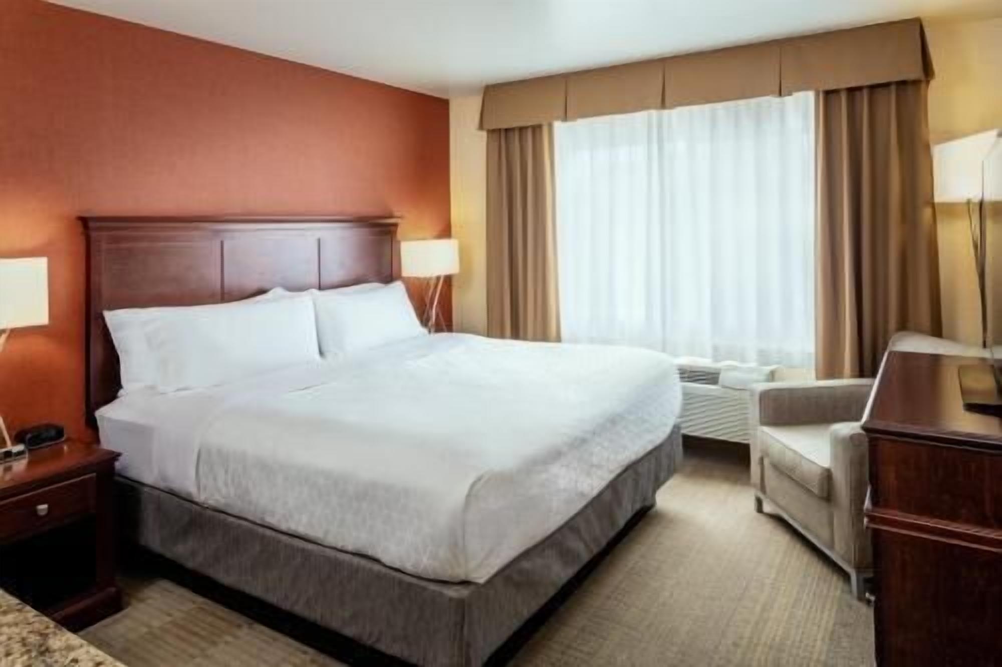 Hypo-allergenic bedding, desk, laptop workspace, blackout drapes