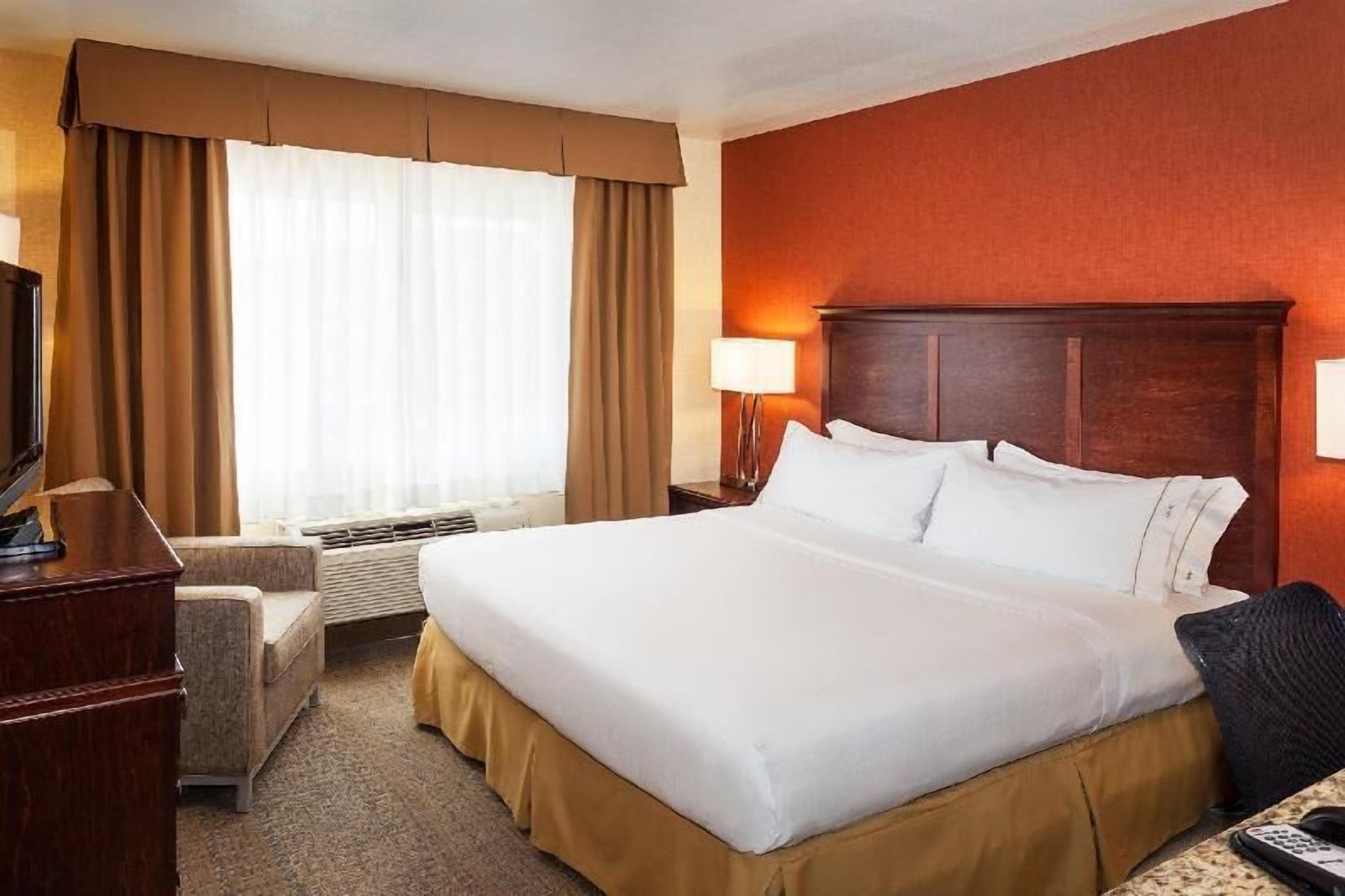 Hypo-allergenic bedding, desk, laptop workspace, blackout drapes