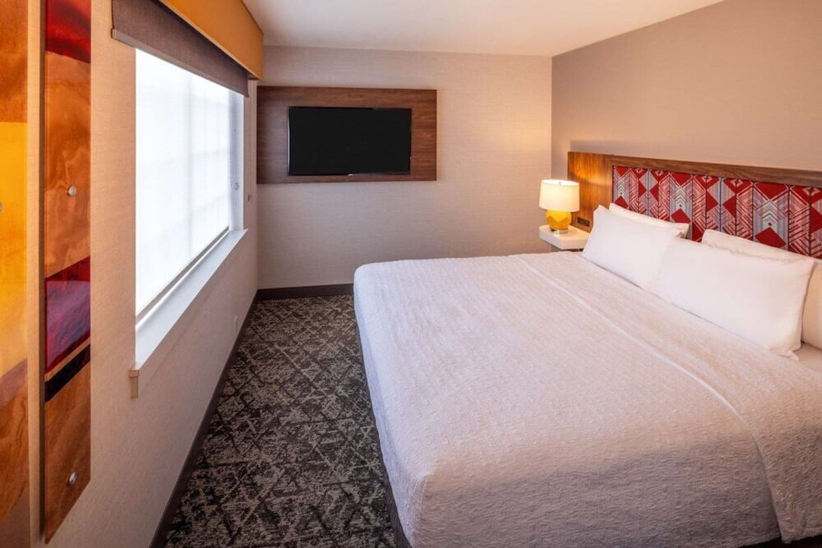 Hypo-allergenic bedding, desk, laptop workspace, blackout drapes