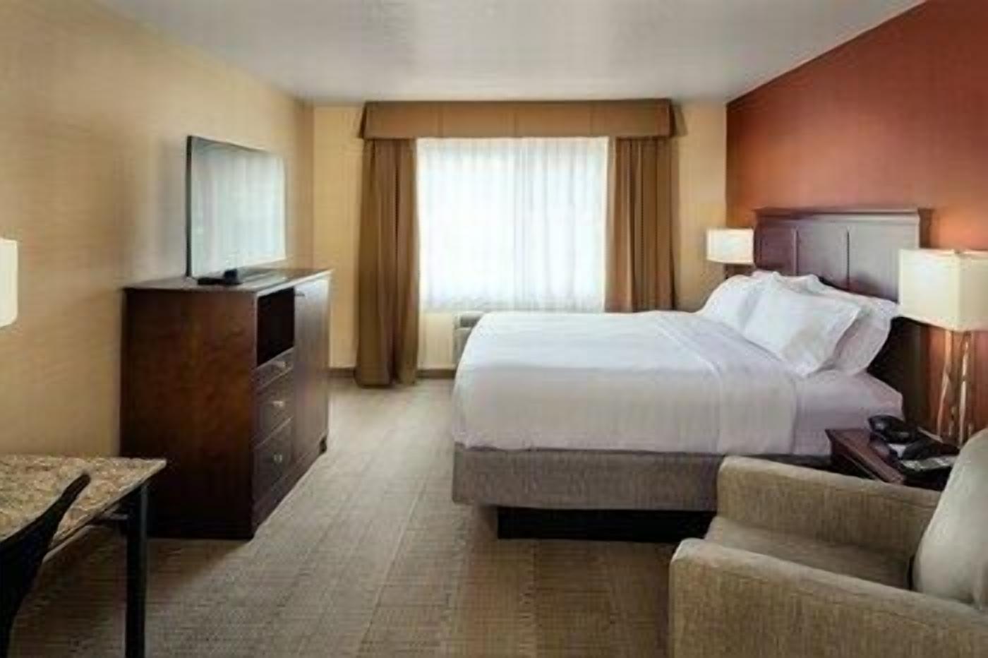 Hypo-allergenic bedding, desk, laptop workspace, blackout drapes