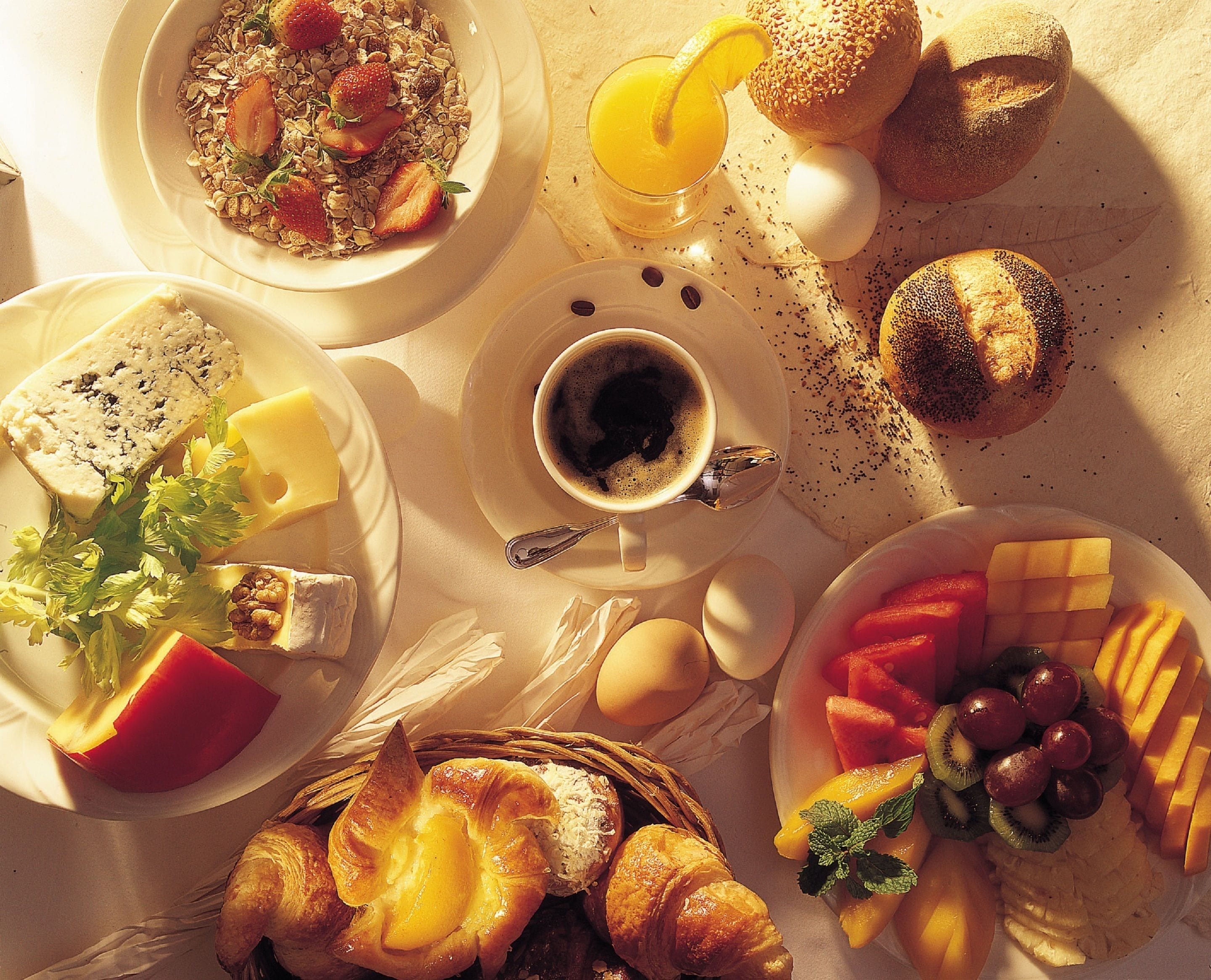 A breakfast spread with various foods and beverages.