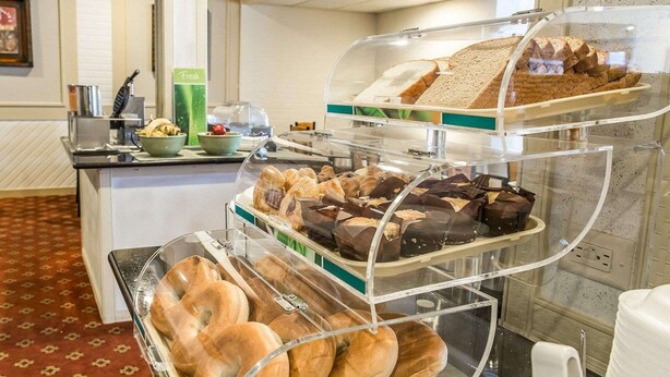 A buffet with various baked goods including bread, pastries, and chocolate items. - Quality Inn & Suites Indiana South (Indiana)
