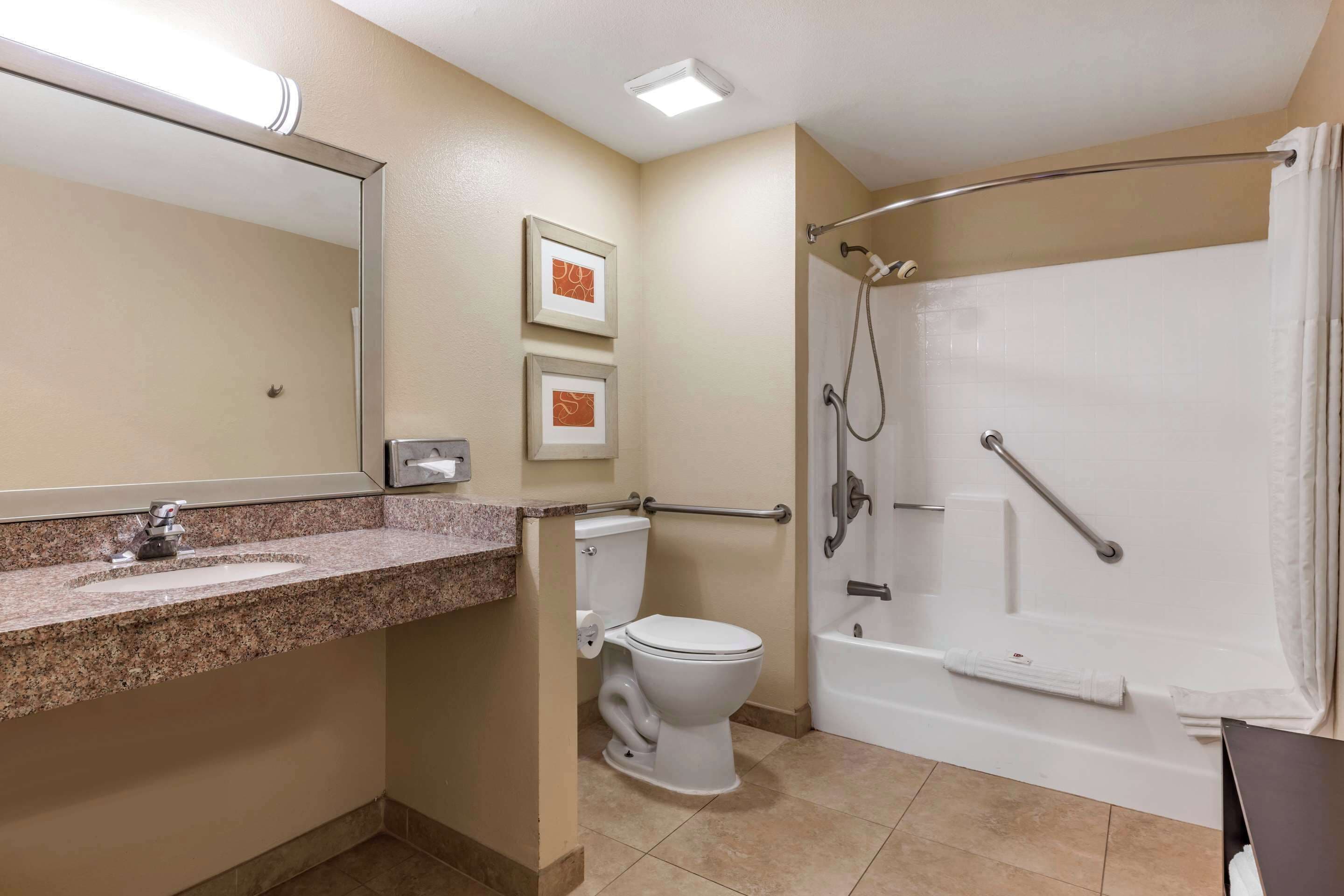 A bathroom with a sink, toilet, and a walk-in shower.