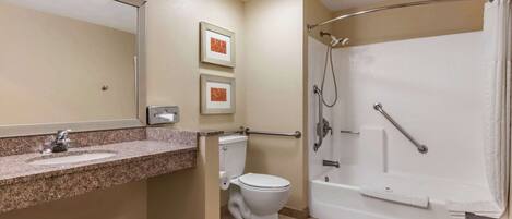 A bathroom with a sink, toilet, and a walk-in shower.