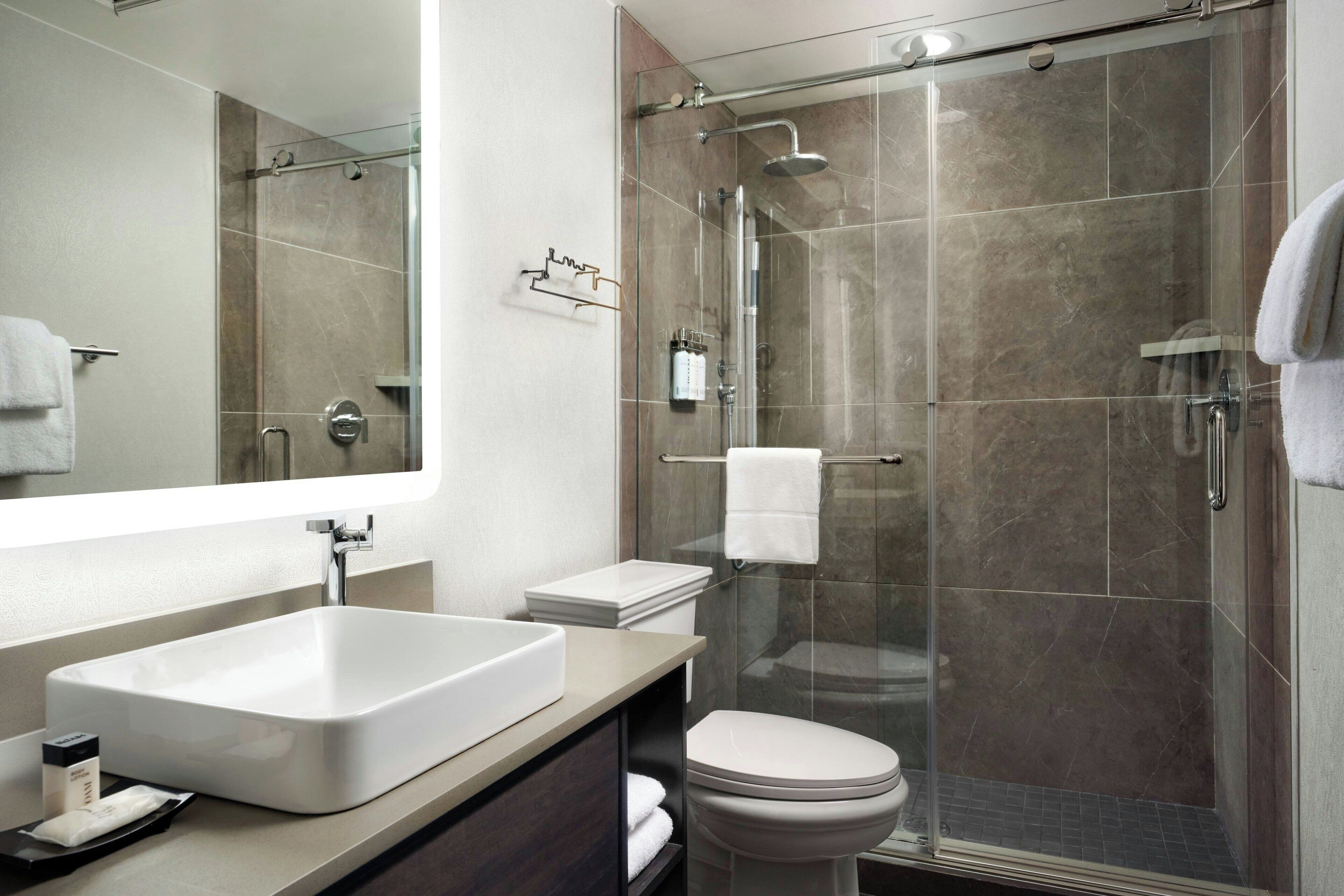 designer toiletries, hair dryer, bathrobes, towels