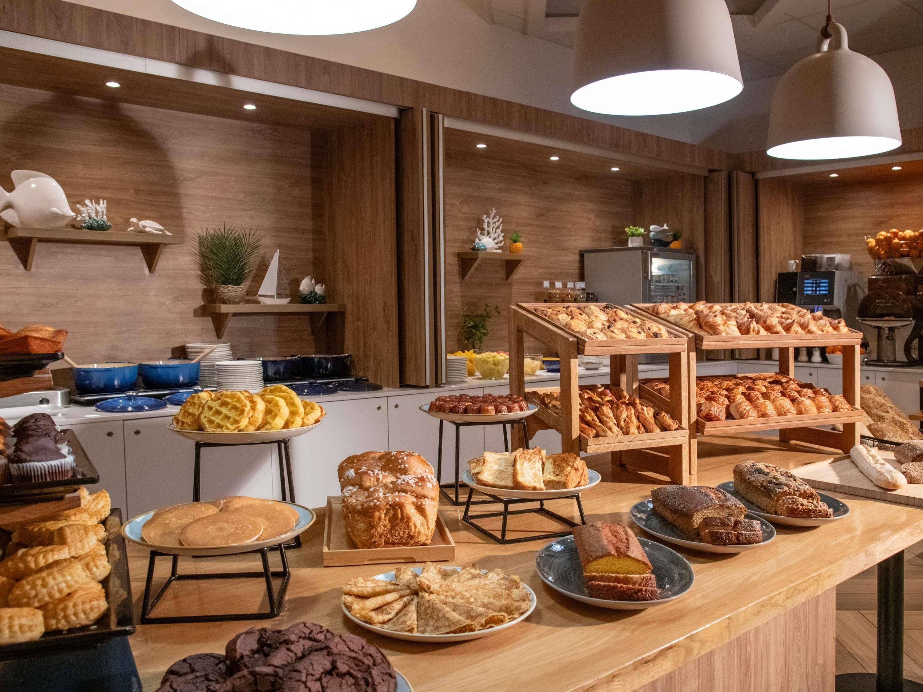 A buffet with various baked goods and pastries.