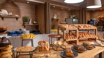 A buffet with various baked goods and pastries.
