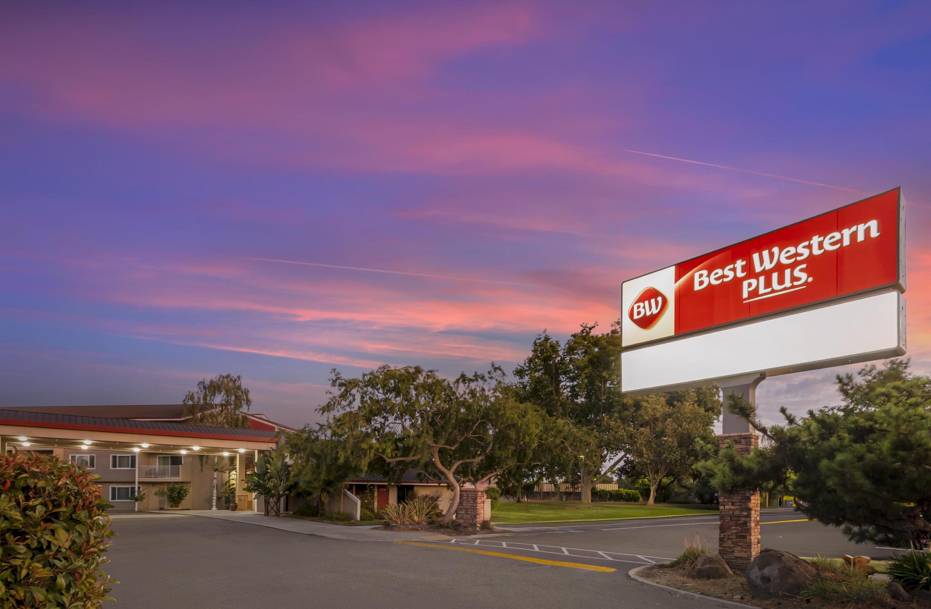 A hotel with a large billboard advertising "Best Western PLUS."