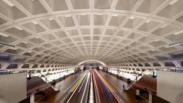 A spacious underground train station with a high, arched ceiling and multiple tracks.