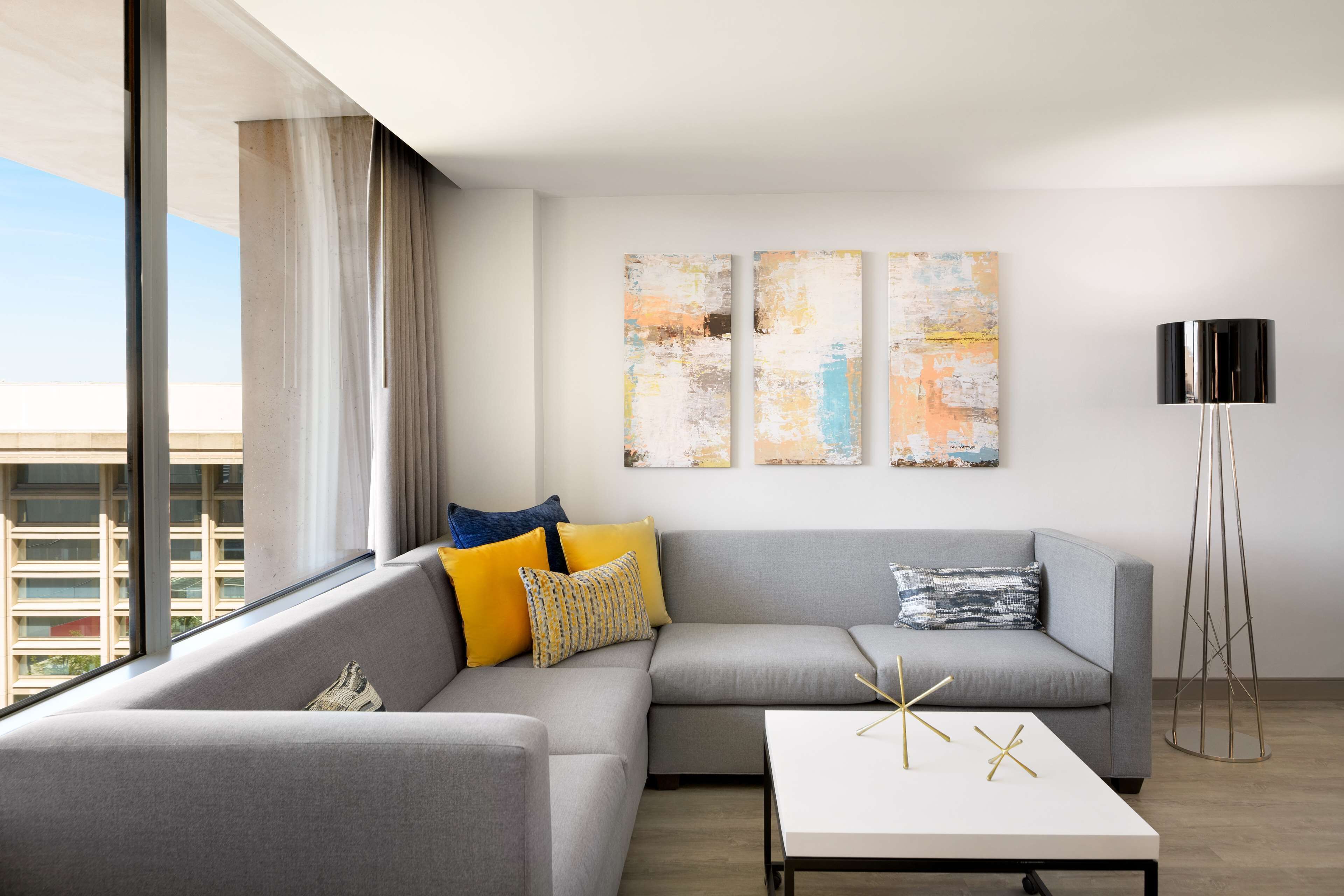 2 king beds 1 bedroom corner suite | living area | 65-inch flat-screen tv with cable channels, tv, netflix