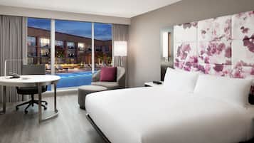 1 King Deluxe Pool View | Premium bedding, in-room safe, desk, laptop workspace