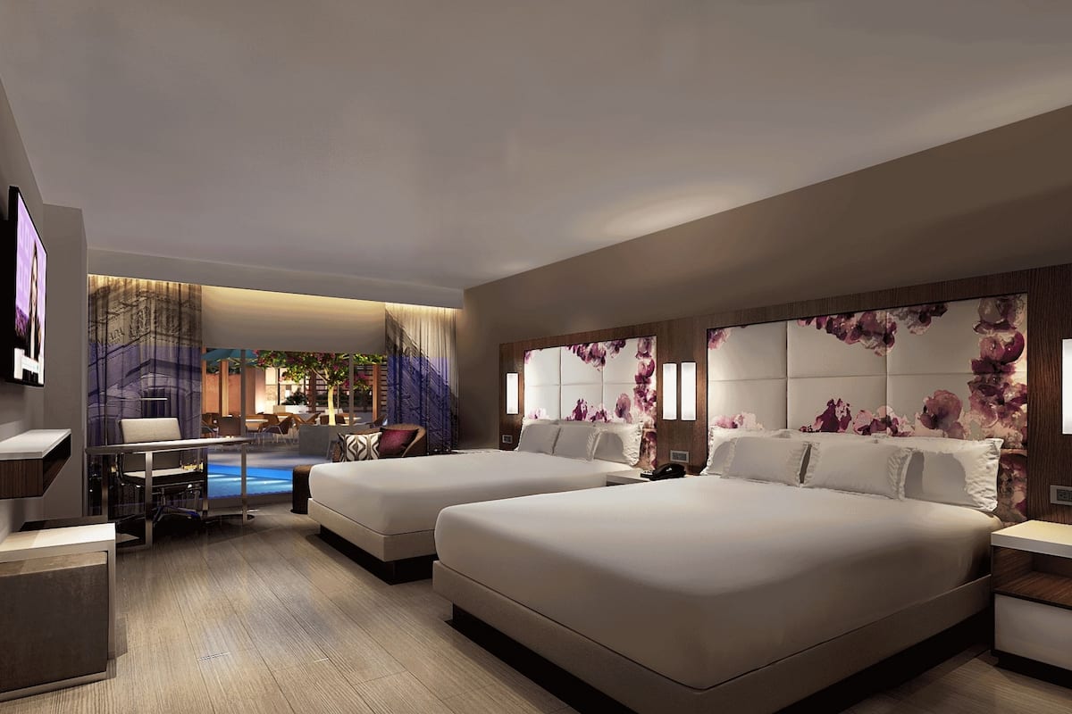 2 king beds deluxe pool view | premium bedding, in-room safe, desk, laptop workspace