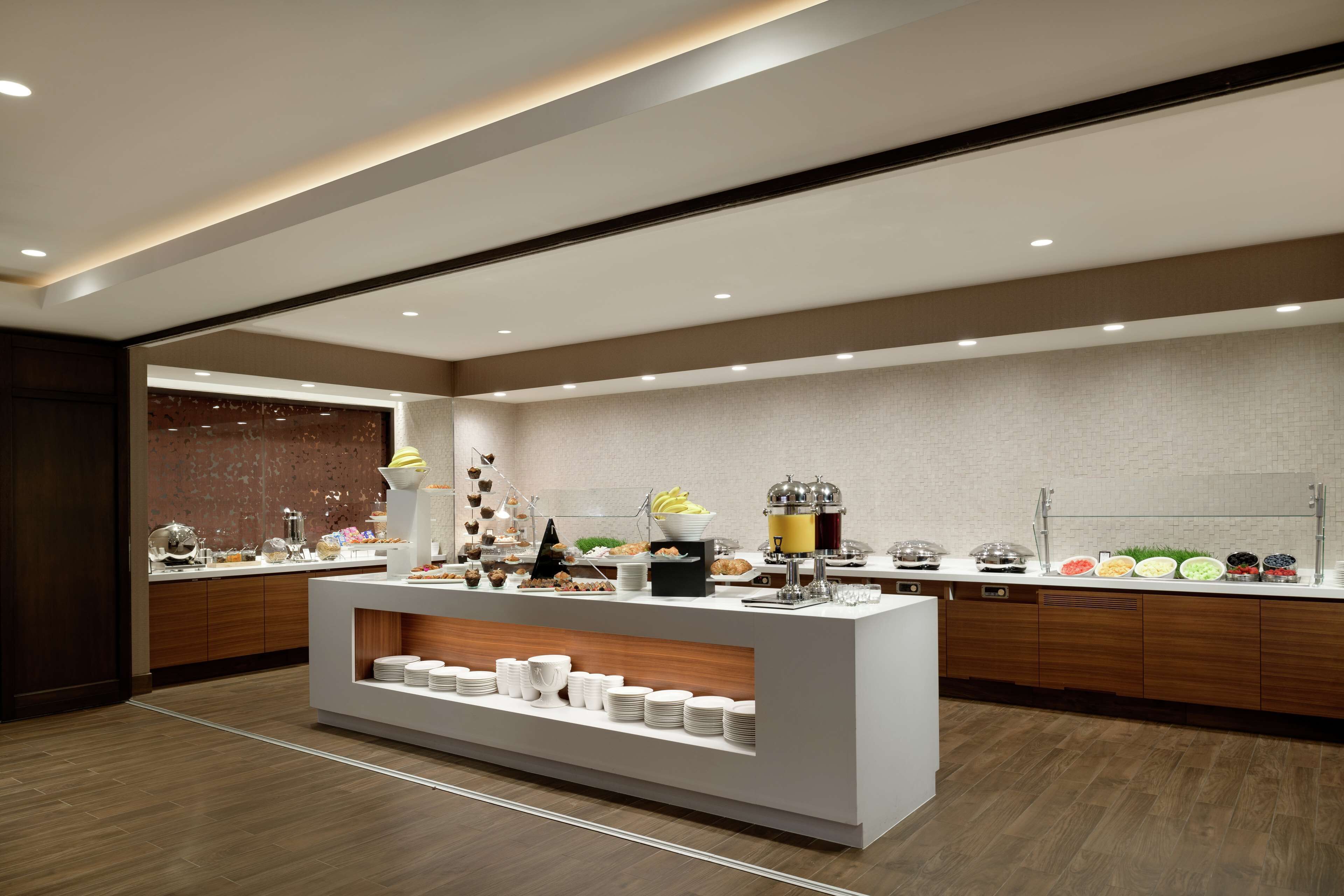 A modern breakfast bar with a variety of food items and a coffee machine.