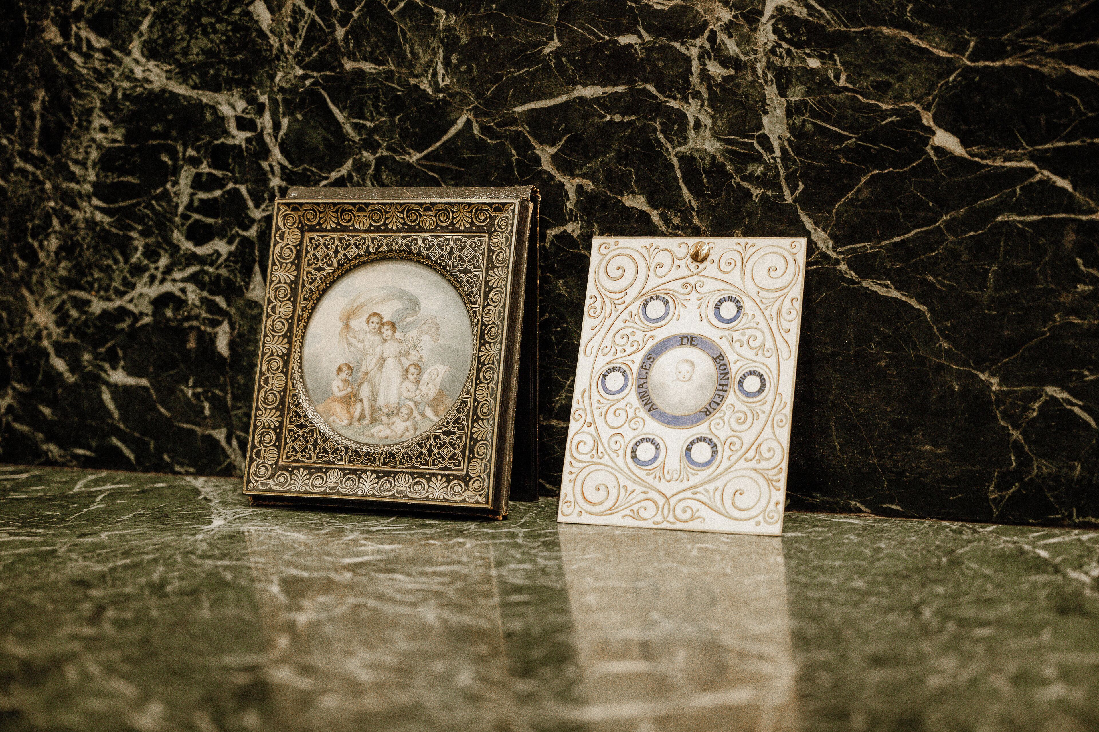 Two framed items on a marble surface.