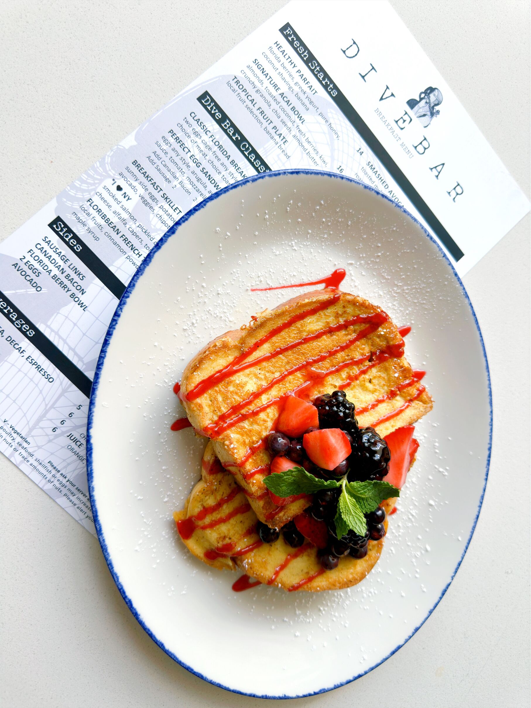 A plate of food with a menu in the background.