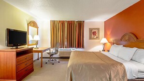 A hotel room with a bed, desk, television, and a window with curtains. - Quality Inn Aberdeen (Aberdeen)