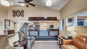 A hotel lobby with leather sofas, a reception desk, and a staircase. - Days Inn by Wyndham Helena (Helena)