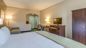 A hotel room with a large bed, a desk with a computer, a chair, a wardrobe, and a TV. - Holiday Inn Express Richmond - Midlothian Turnpike by IHG (Richmond)