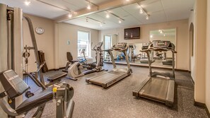A gym with treadmills, stationary bikes, and weight machines. - Holiday Inn Express Richmond - Midlothian Turnpike by IHG (Richmond)