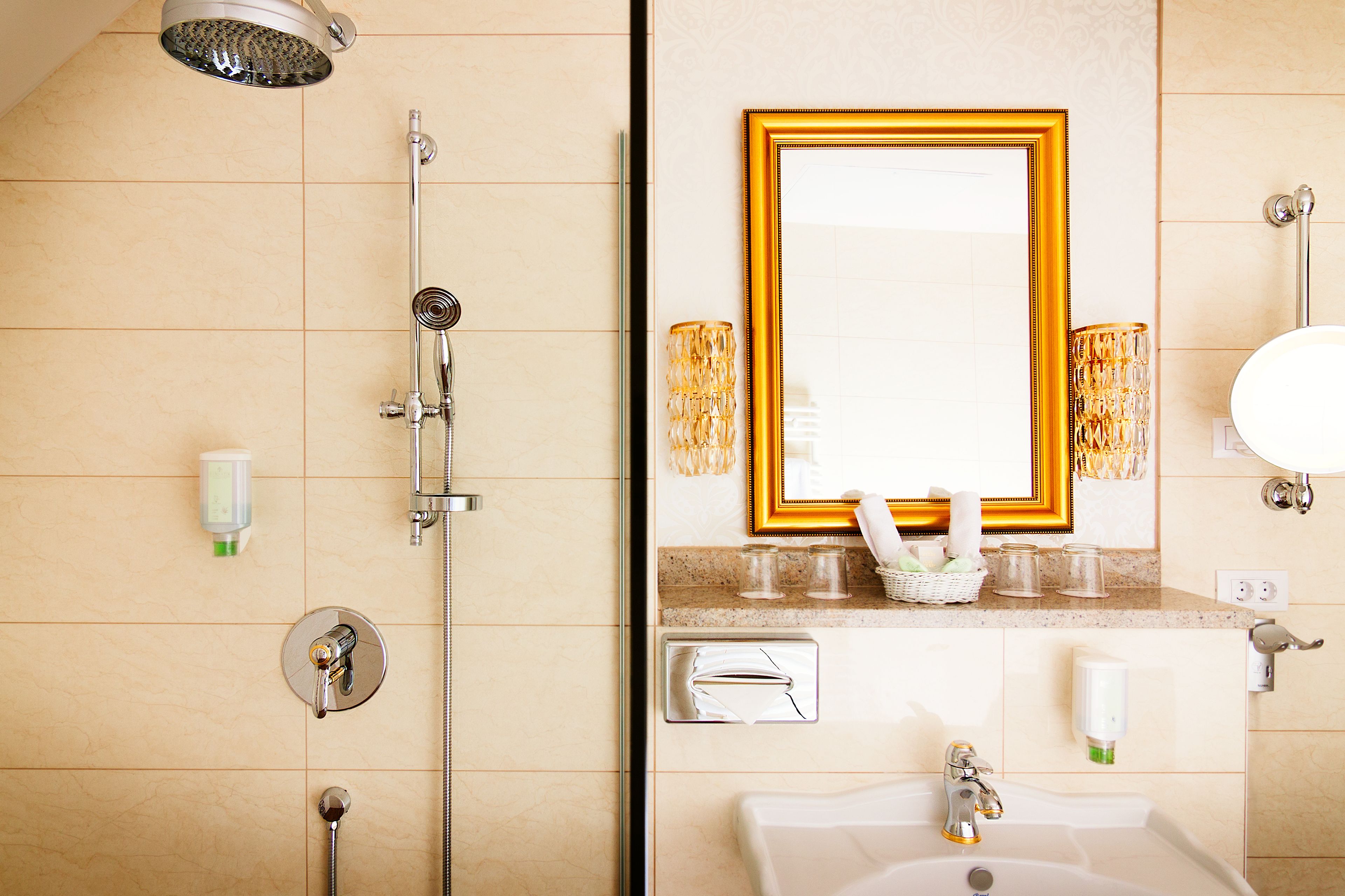 A bathroom with a shower, sink, and mirror.
