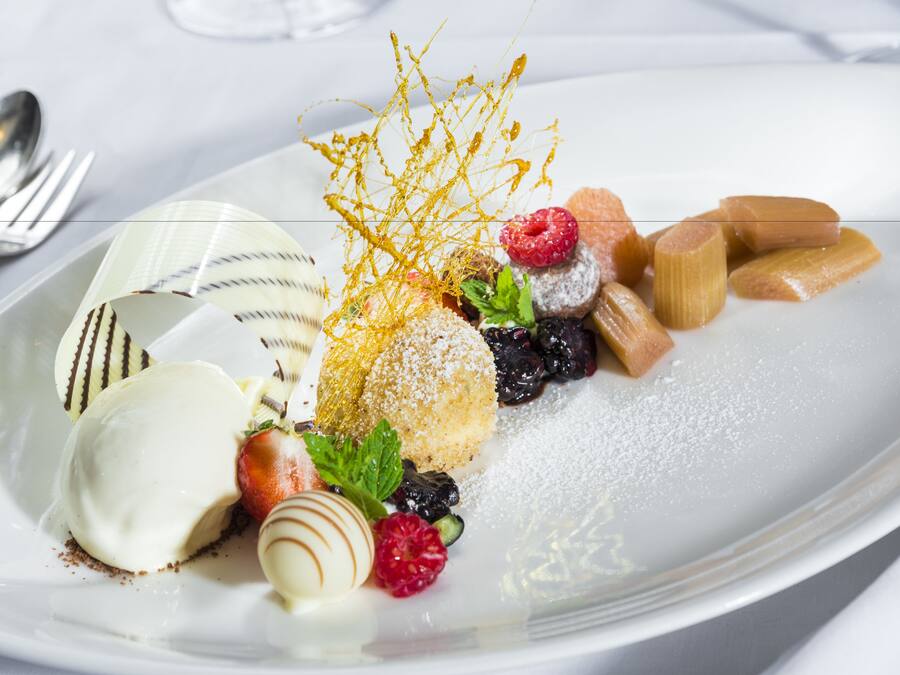 A dessert plate with various sweets and fruits.