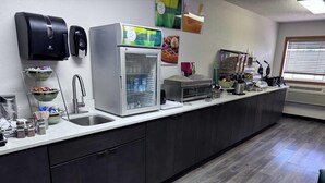 A kitchen with a sink, a refrigerator, and a coffee machine. - Quality Inn Spearfish I-90 (Spearfish)