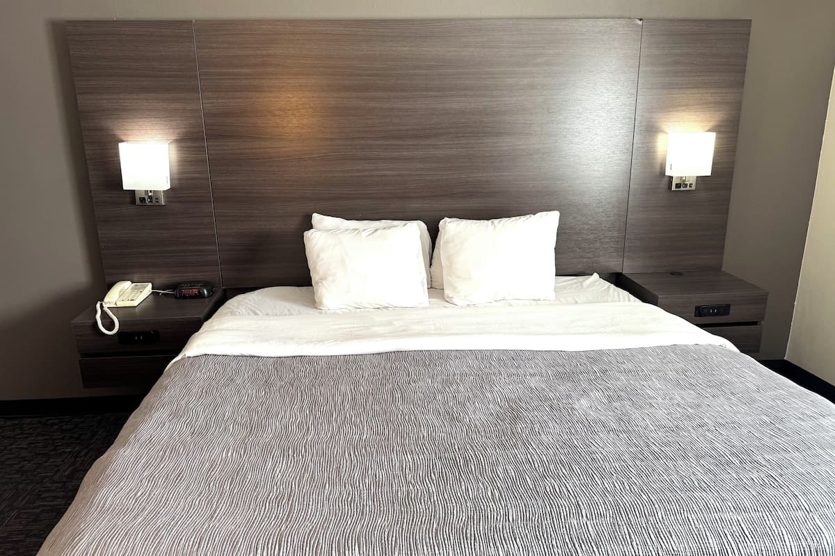 Roupas de cama premium, escrivaninha, espaço de trabalho para notebook