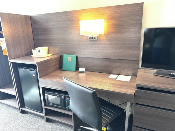 Relax in a stylish room with a desk, comfortable chair, flat-screen TV, and convenient amenities.