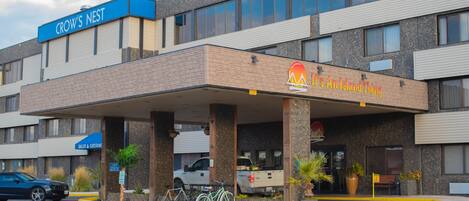 A hotel with a 'CROW'S NEST' sign, a 'SALES & CATERING' sign, and a 'It's An Island Thing' sign.