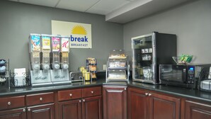 A breakfast area with a coffee machine, toaster, and microwave. - Days Inn by Wyndham West Covina (West Covina)
