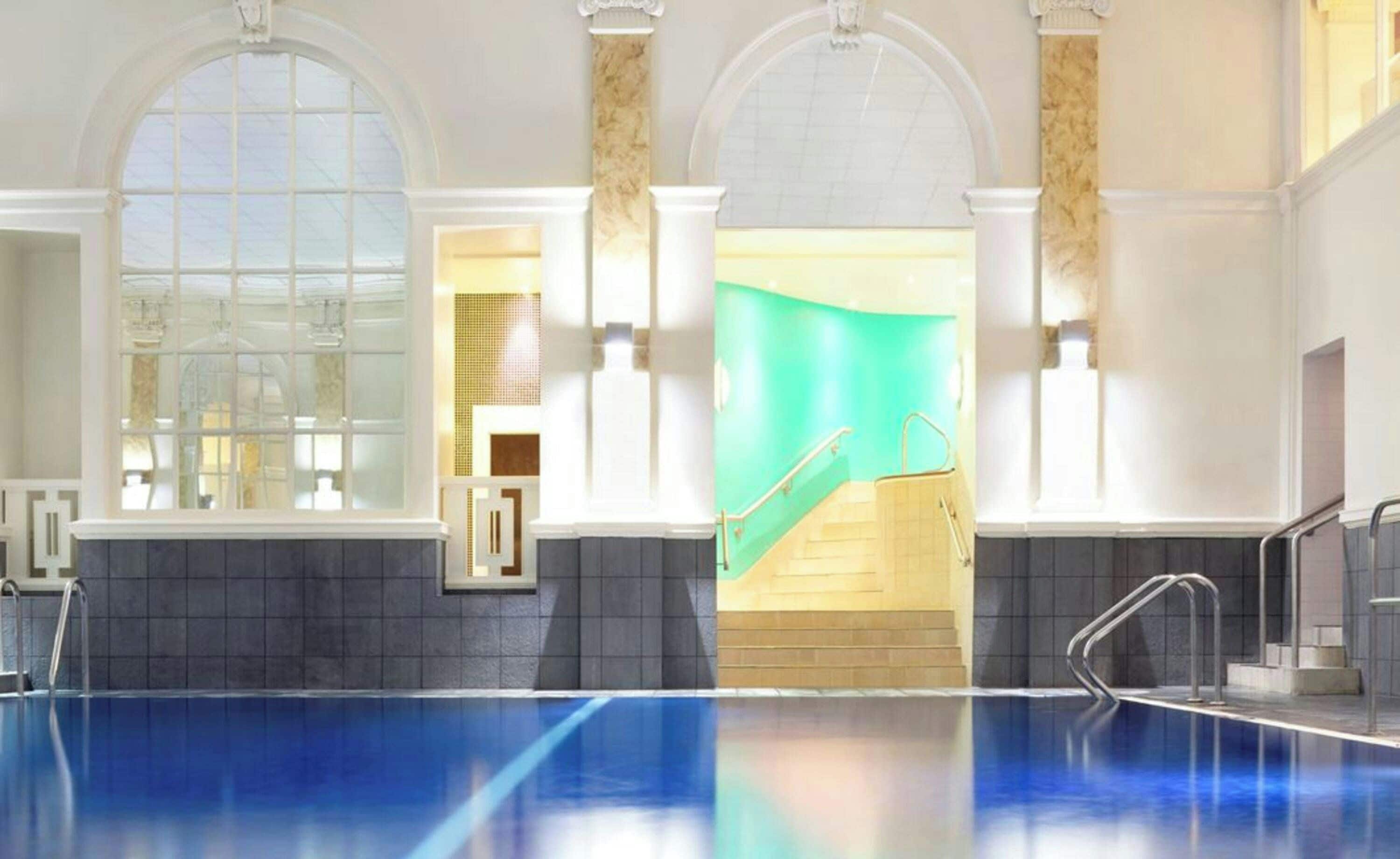 A swimming pool with a clear view of the surrounding area, including a staircase leading to an upper level.