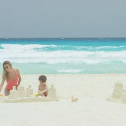 On the beach, white sand, sun loungers, beach umbrellas
