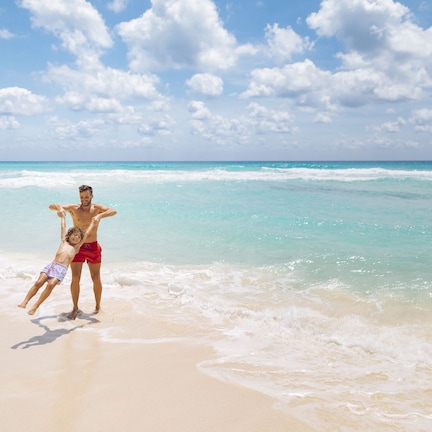 A beach scene with a sandy shore and ocean waves.