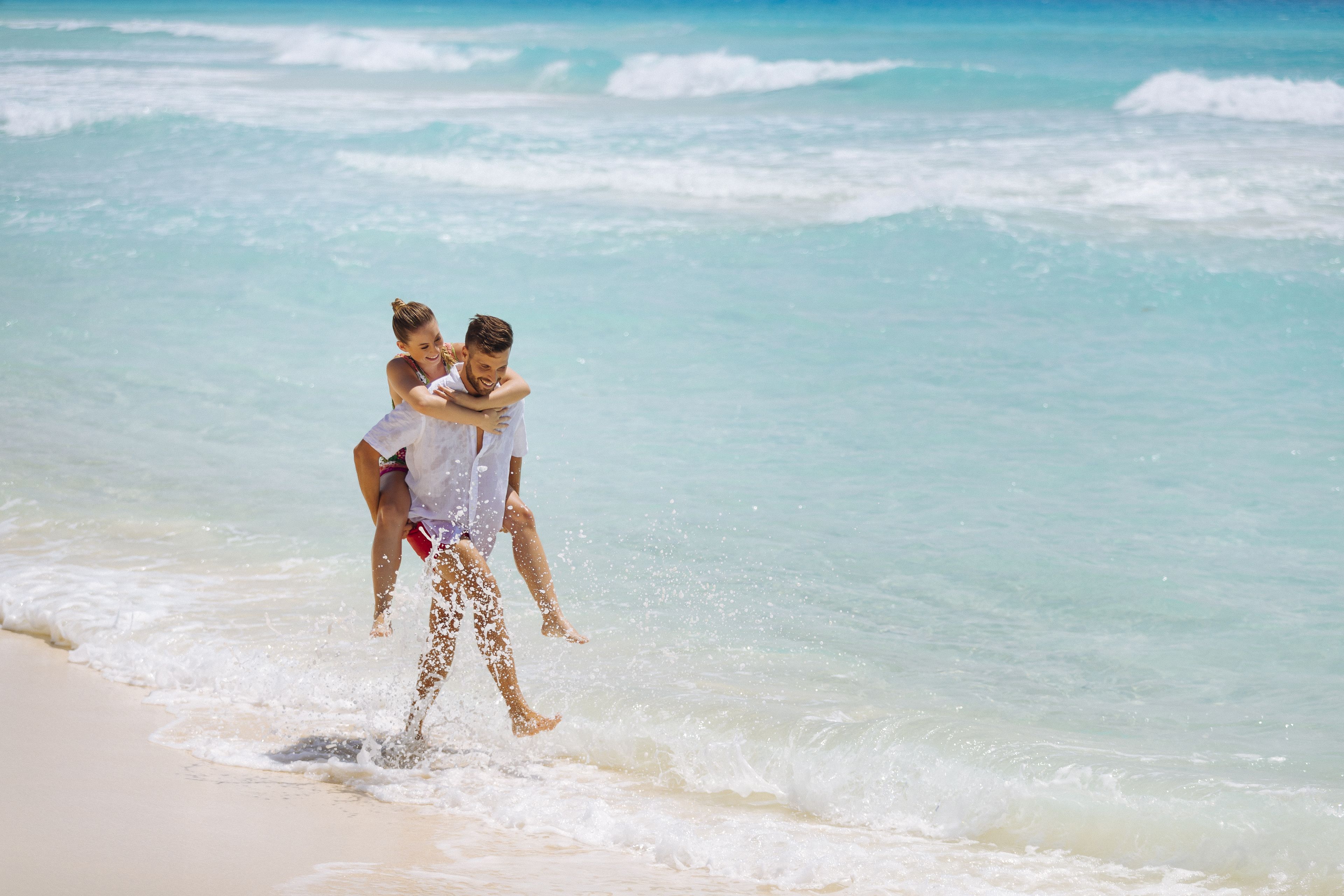 On the beach, white sand, sun loungers, beach umbrellas
