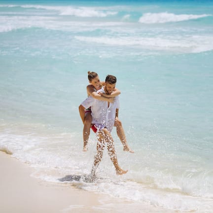 On the beach, white sand, sun loungers, beach umbrellas