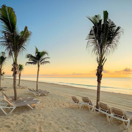 On the beach, white sand, sun loungers, beach umbrellas