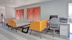 A modern office space with a sofa, chairs, a desk, and a printer. - Quality Inn Pierre - Fort Pierre (Pierre)