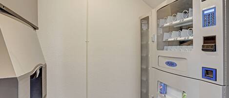 A vending machine with a glass door, a push button, and a coin slot.