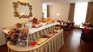 A breakfast buffet with various food items and beverages.