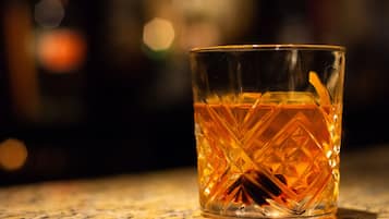 A clear glass with a geometric pattern, placed on a surface.